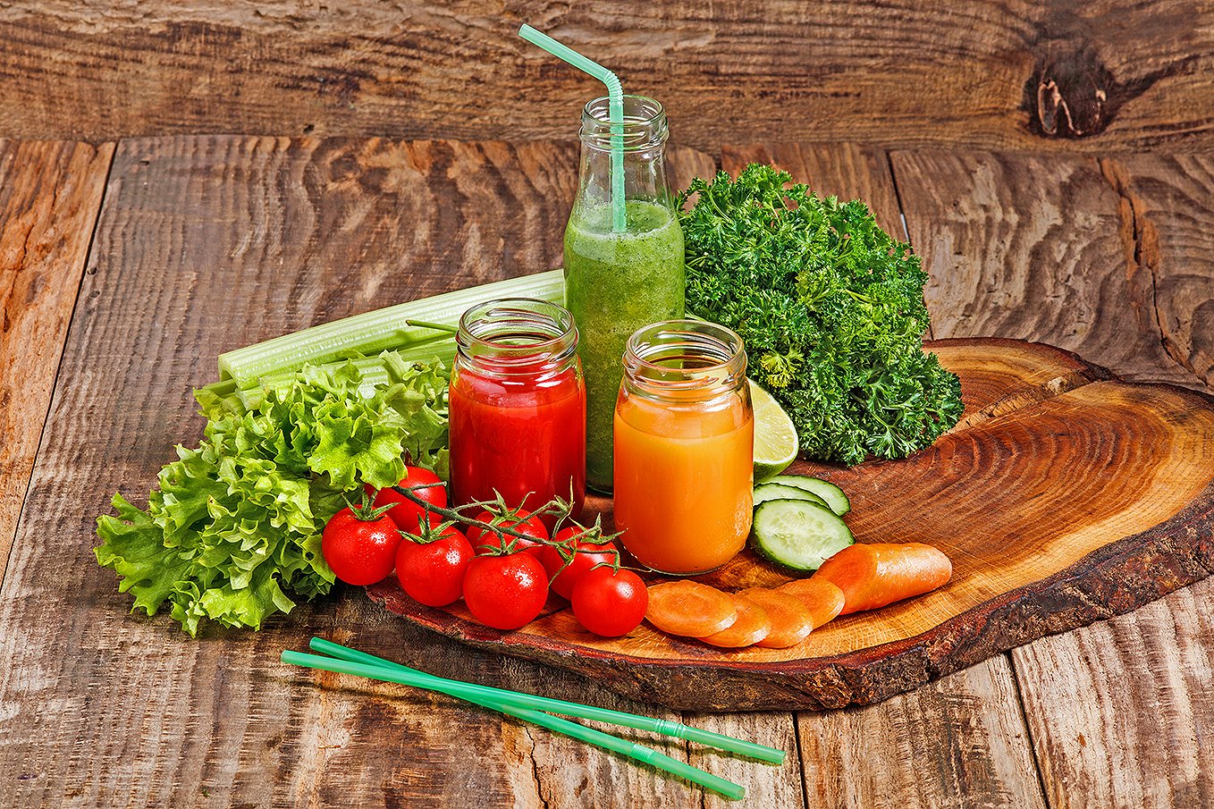 The bottles with fresh vegetable juices on wooden table. Detox diet.